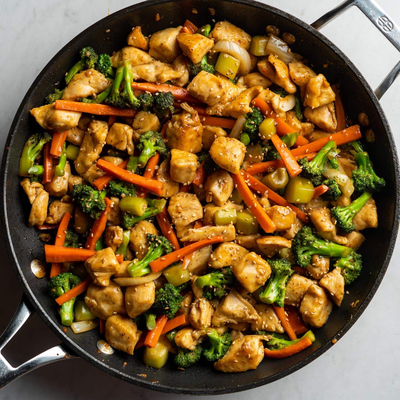 chicken and broccoli with vegetables in a pan