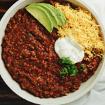 poblano beef chili in a bowl with toppings