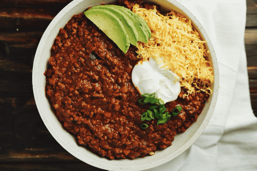beef chili in a bowl with toppings