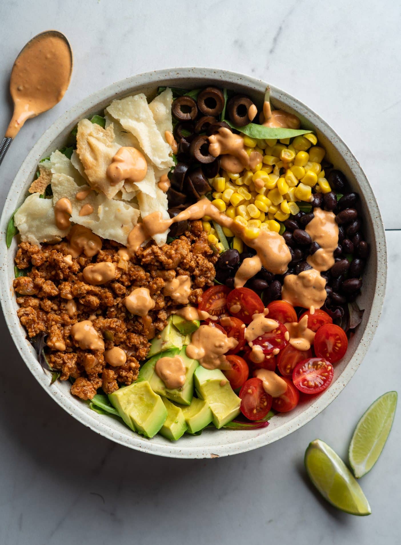 turkey taco meat salad with toppings in a bowl