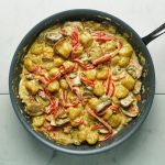 cauliflower gnocchi with peppers and mushrooms in Alfredo sauce in a pan
