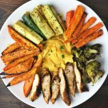 butternut squash hummus with roasted vegetables and chicken on a plate