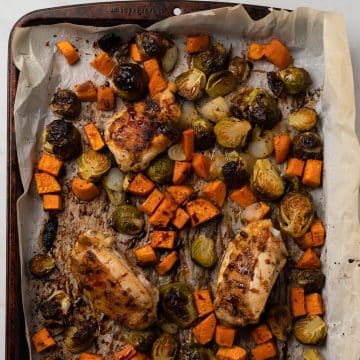 roasted chicken and vegetables on a sheet tray