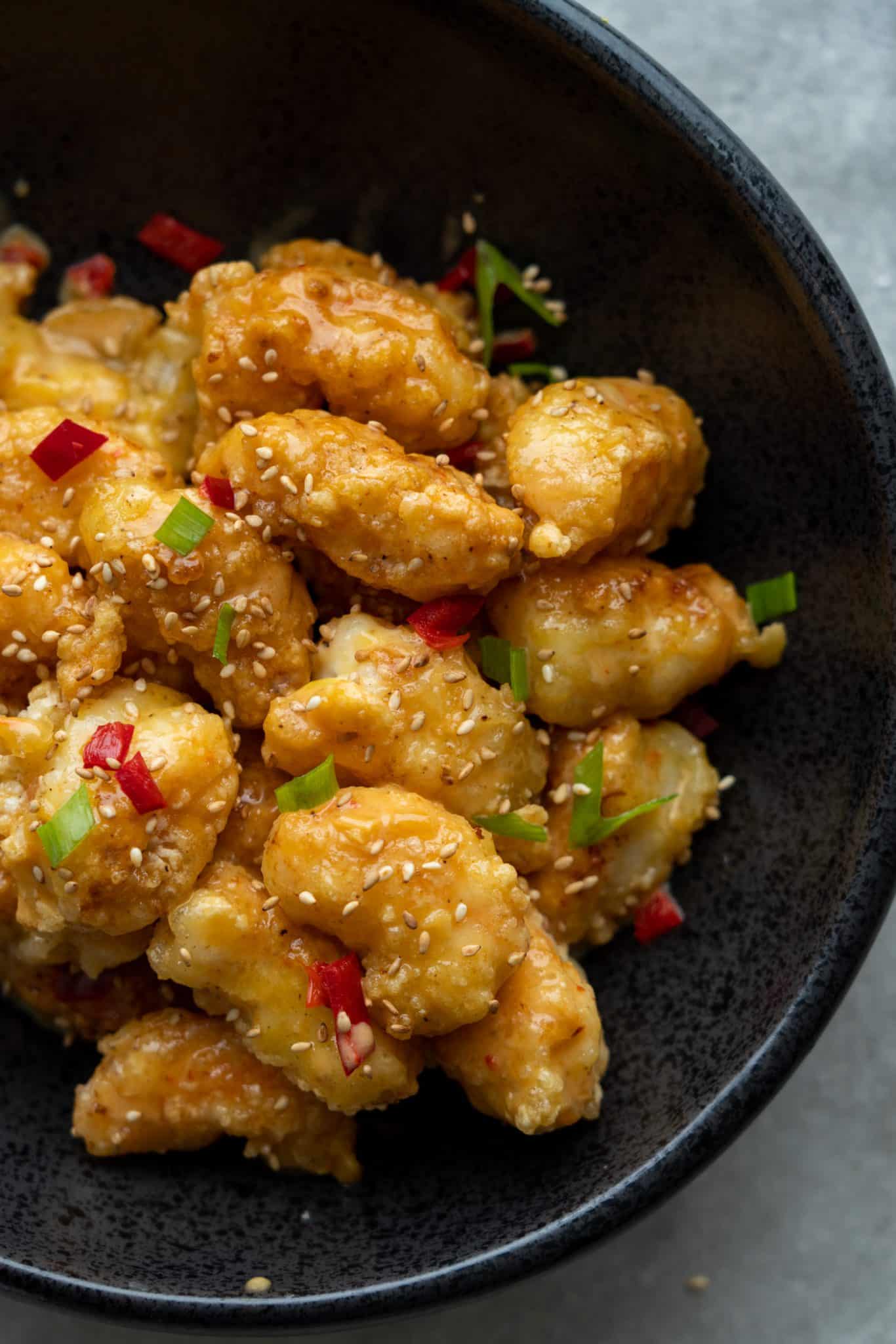 coated shrimp tossed in a sweet Thai chili sauce served in a bowl