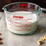 Almond Cashew Cream in a measuring cup
