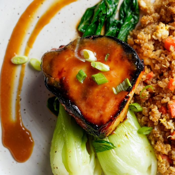 miso glazed seabags on a bed of bok choy with quinoa fried rice