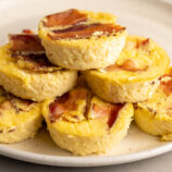 Bacon and Gruyere Egg bites stacked on a plate.