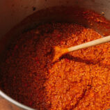 Bolognese Meat Sauce in a big sauce pot with a wooden spoon in the middle